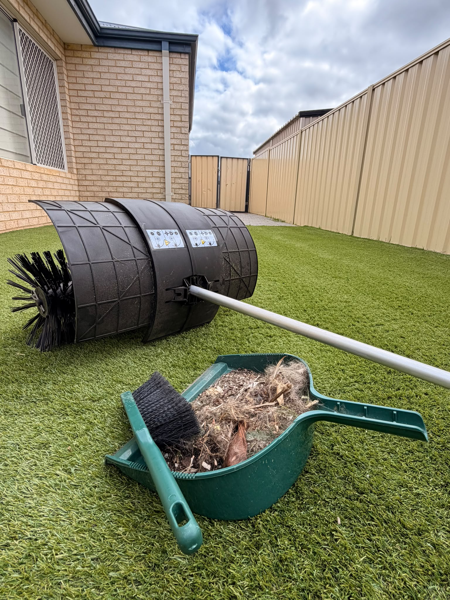 Dustpan and brush full of leaf litter, hair and compacted debris lifted from artificial turf by the STIHL KB-KM bristle brush
